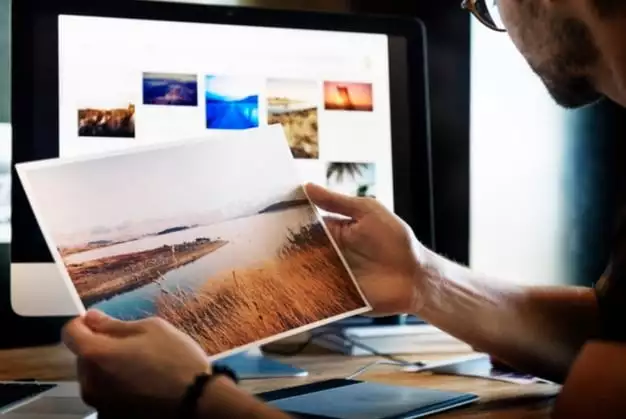 man looking at photographs