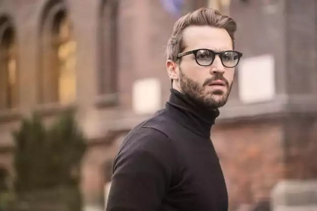 man with glasses in turtleneck